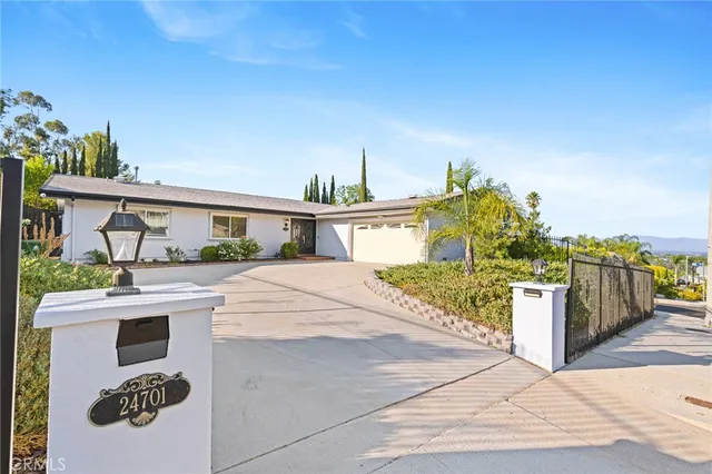 a large kitchen with stainless steel appliances kitchen island granite countertop a sink and cabinets