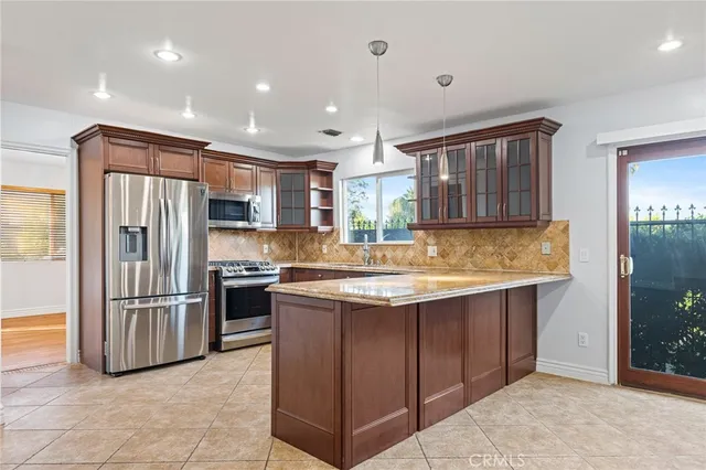 a kitchen with a refrigerator and a counter top space