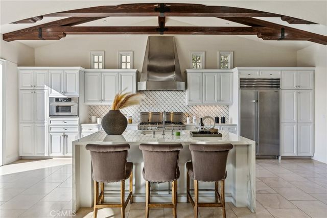 a kitchen with stainless steel appliances granite countertop a sink and cabinets