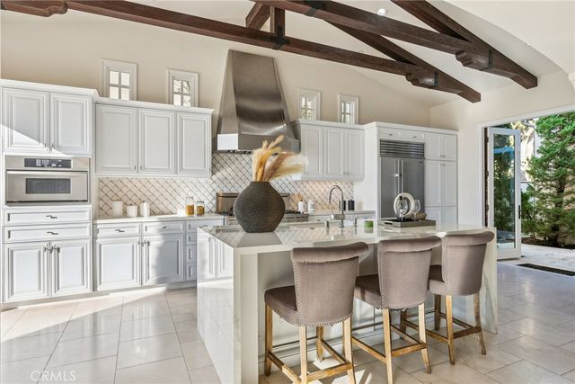 a bedroom with a large bed and a flat screen tv