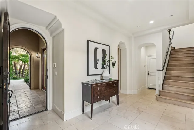 a view of a hallway with windows and entryway