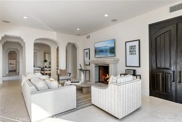 a living room with furniture white walls and painting on the wall