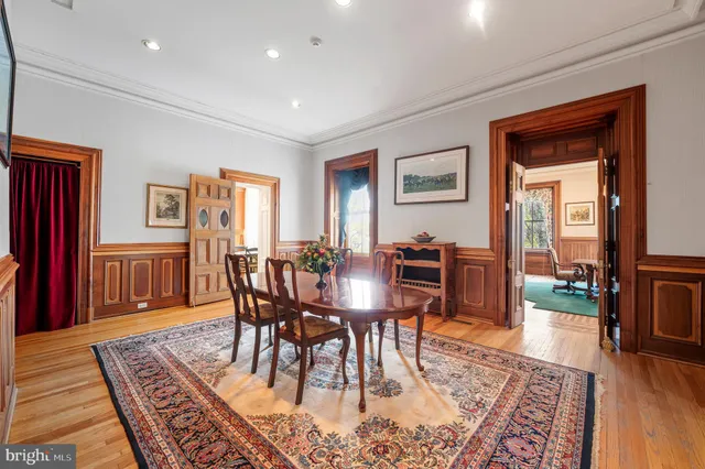 a view of a a dining room with furniture window and wooden floor