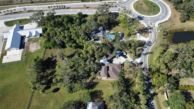 an aerial view of residential house with outdoor space and swimming pool