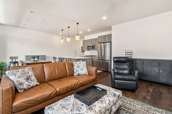 a large living room with a couch and a wooden floor
