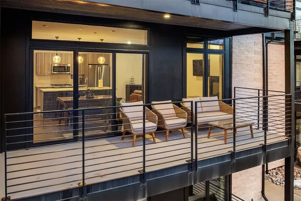 a view of a balcony with chairs