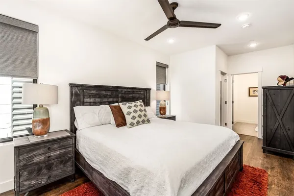 a bedroom with a bed and a refrigerator