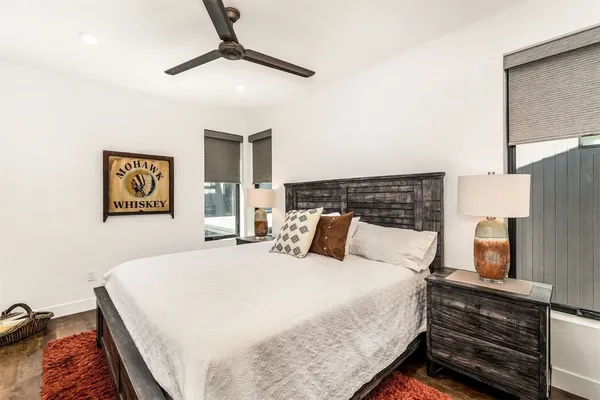 a bedroom with a bed and ceiling fan