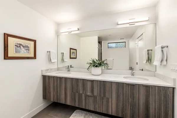 a bathroom with a double vanity sink and a mirror