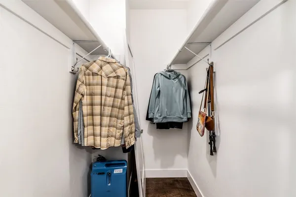 a view of walk in closet with clothes and shoes