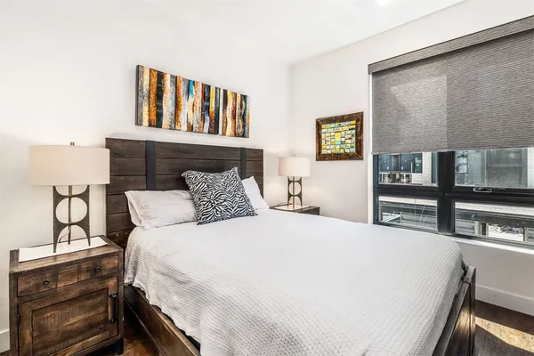 a bedroom with a bed and dresser