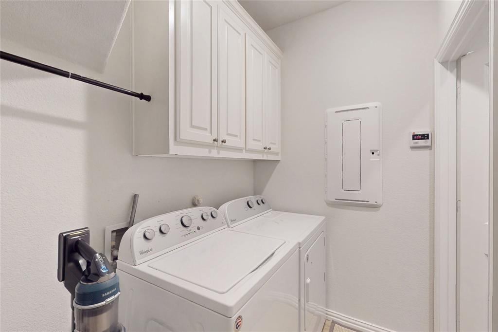 1997 Kieva Place Allen, TX 75013 - Photo 24 of 40 Laundry room featuring cabinet space, washing machine and clothes dryer, and electric panel