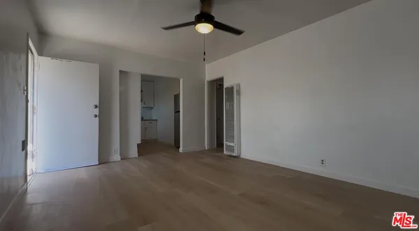 a view of empty room with ceiling fan