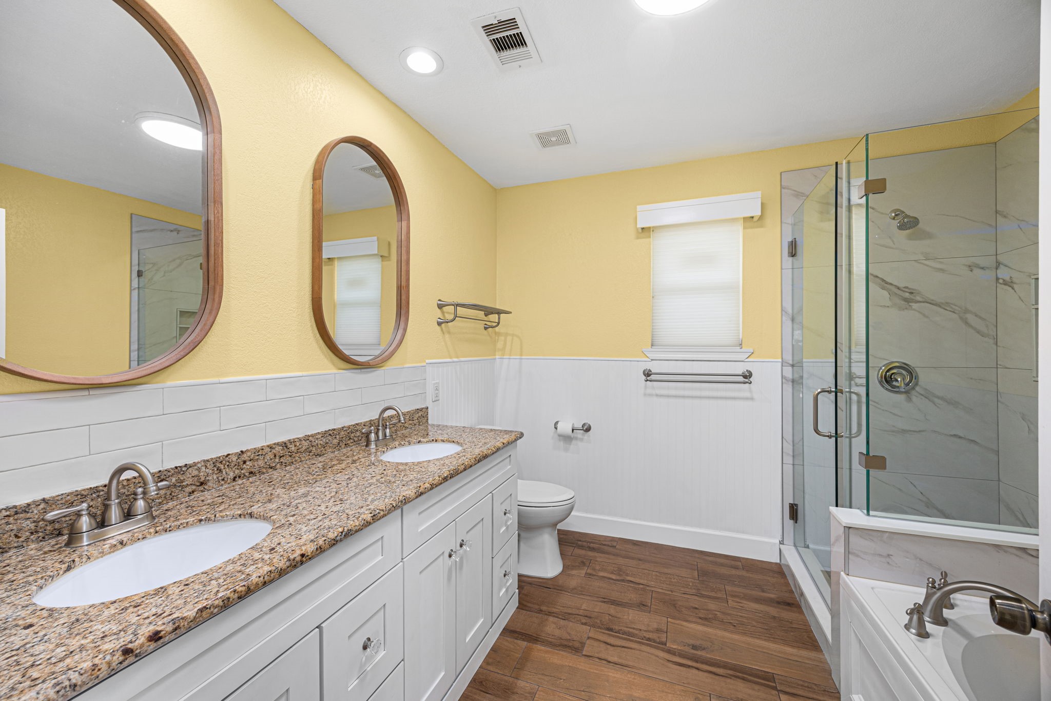 710 East 28th Street Houston, TX 77009 - Photo 13 of 44 a bathroom with a granite countertop double vanity sink and a mirror