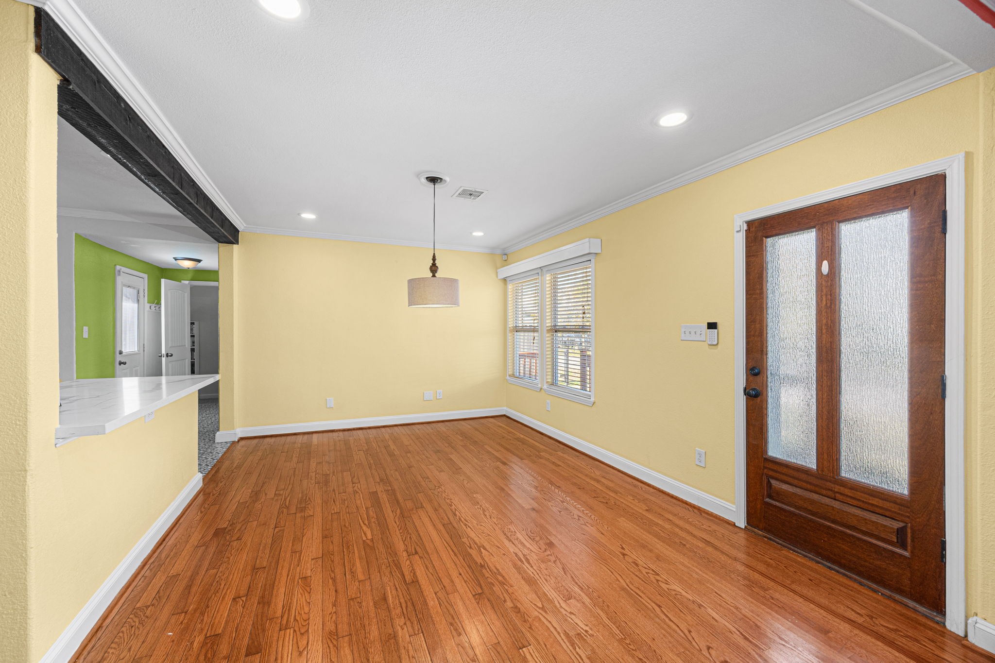 710 East 28th Street Houston, TX 77009 - Photo 17 of 44 a view of an empty room with wooden floor and a window