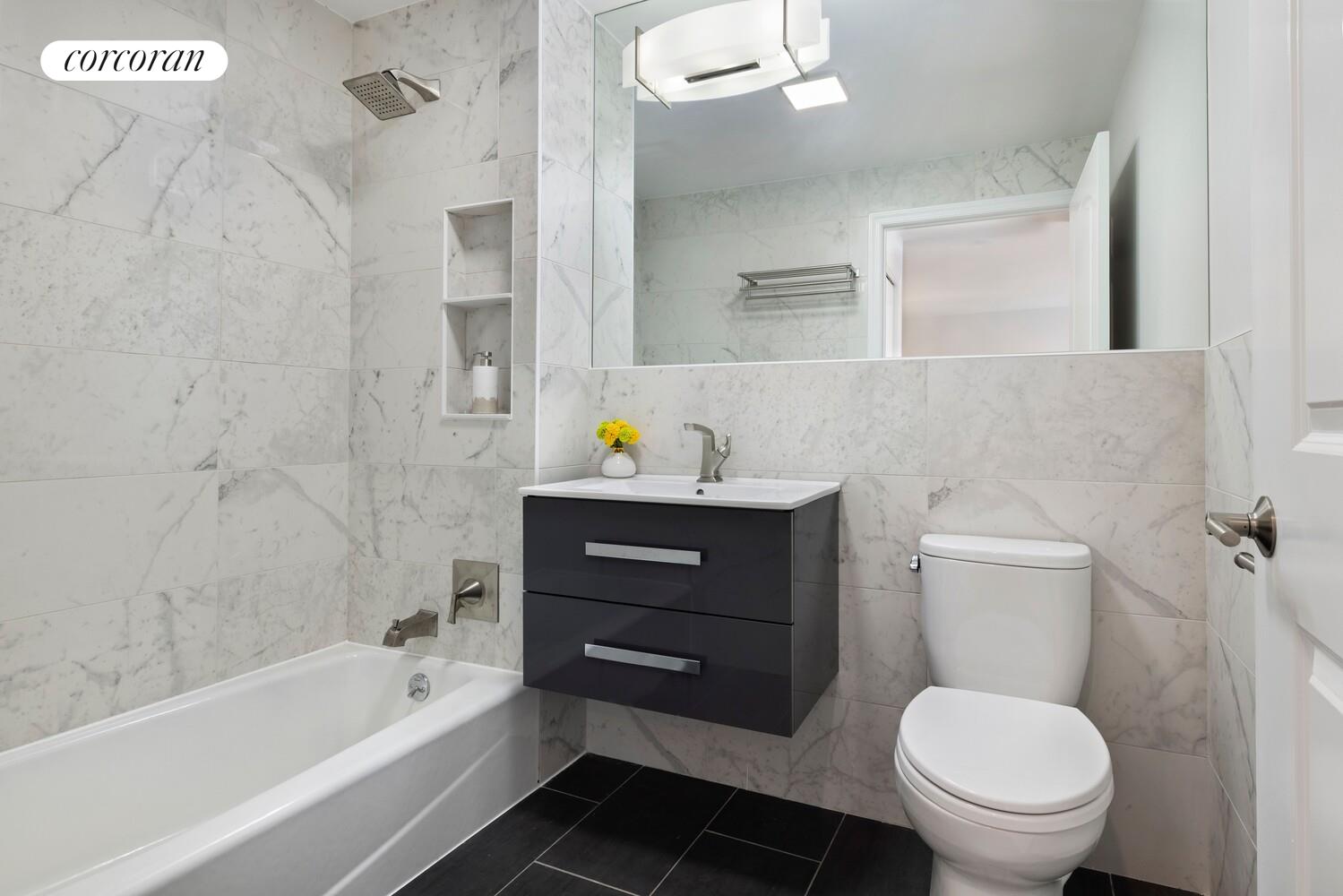 23-16 31st Avenue, Unit 2B Queens, NY 11106 - Photo 5 of 10 a bathroom with a sink a toilet and a bathtub