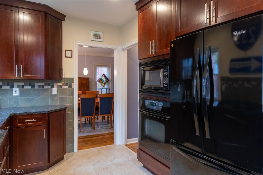 3433 Bradford Road Cleveland, OH 44118 - Photo 8 of 35 More cabinetry surrounds the newer fridge, wall oven & built in microwave, all Incl. Ahead is the Dinning rm & to the right is the stairs to the 2nd flr & living rm.