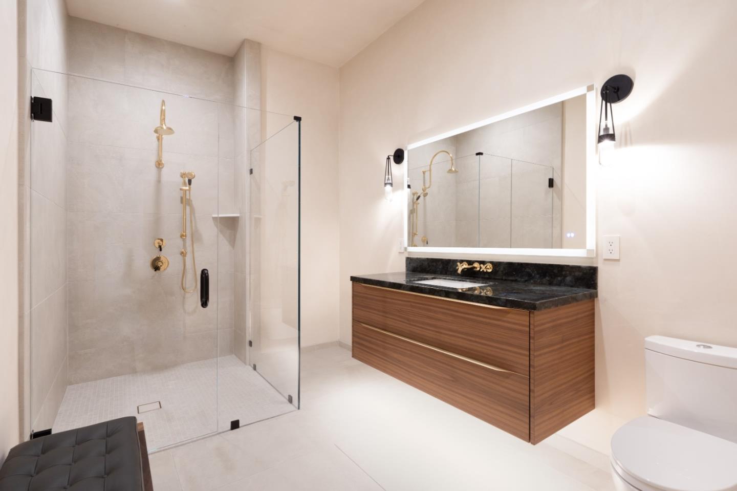 520 Lighthouse Avenue, Unit 301 Pacific Grove, CA 93950 - Photo 11 of 14 a bathroom with a granite countertop sink a toilet and shower