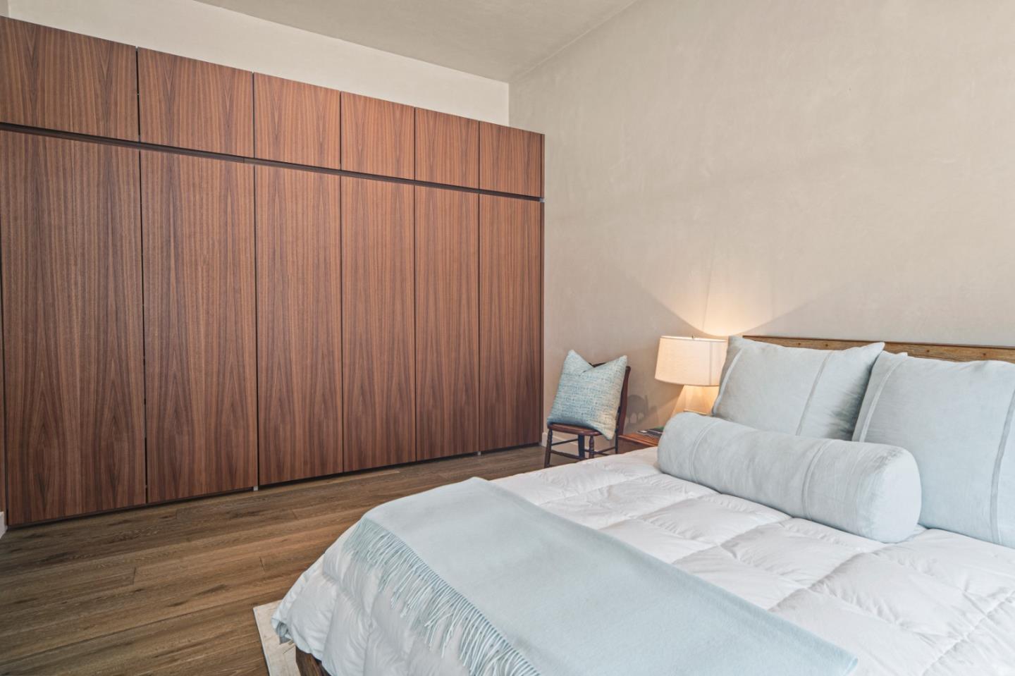 520 Lighthouse Avenue, Unit 301 Pacific Grove, CA 93950 - Photo 13 of 14 a bedroom with a bed and a curtain