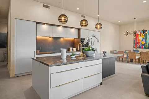 a kitchen with cabinets and window