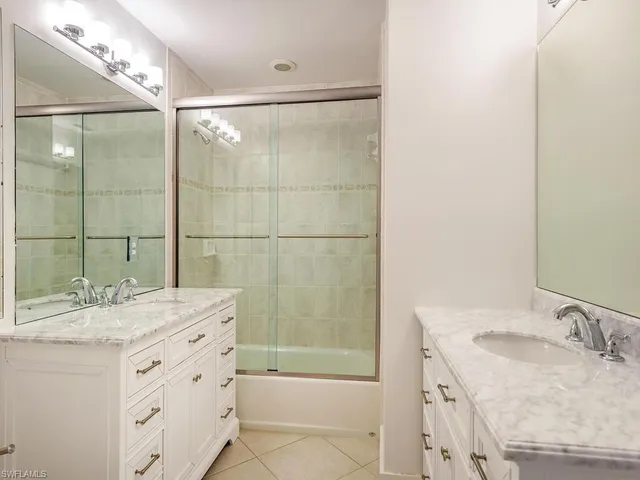 a bathroom with a granite countertop sink a shower and a mirror
