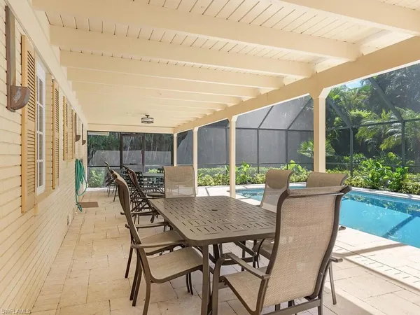 a view of a patio with a table and chairs