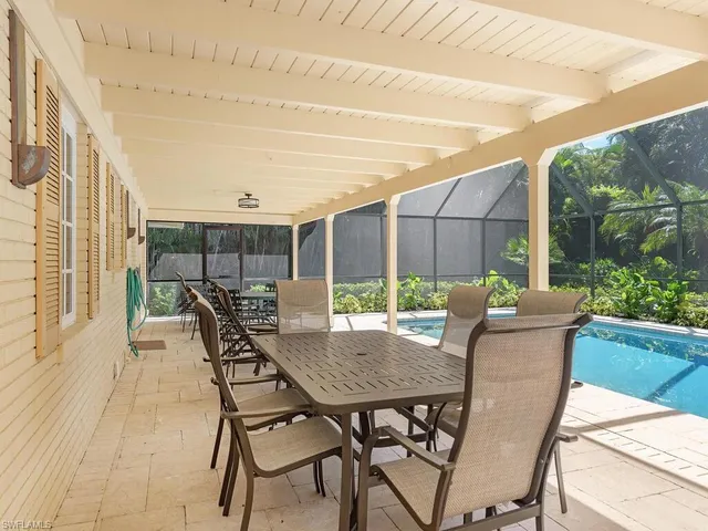 a view of a patio with a table and chairs
