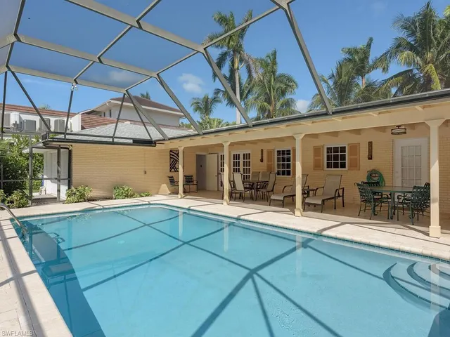 a view of a house with a backyard and a patio