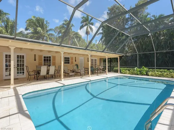 a view of a house with a backyard and a patio