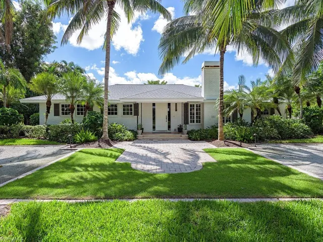 a front view of house with yard and green space