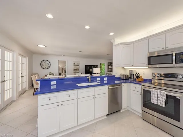 a kitchen with stainless steel appliances granite countertop a sink and cabinets