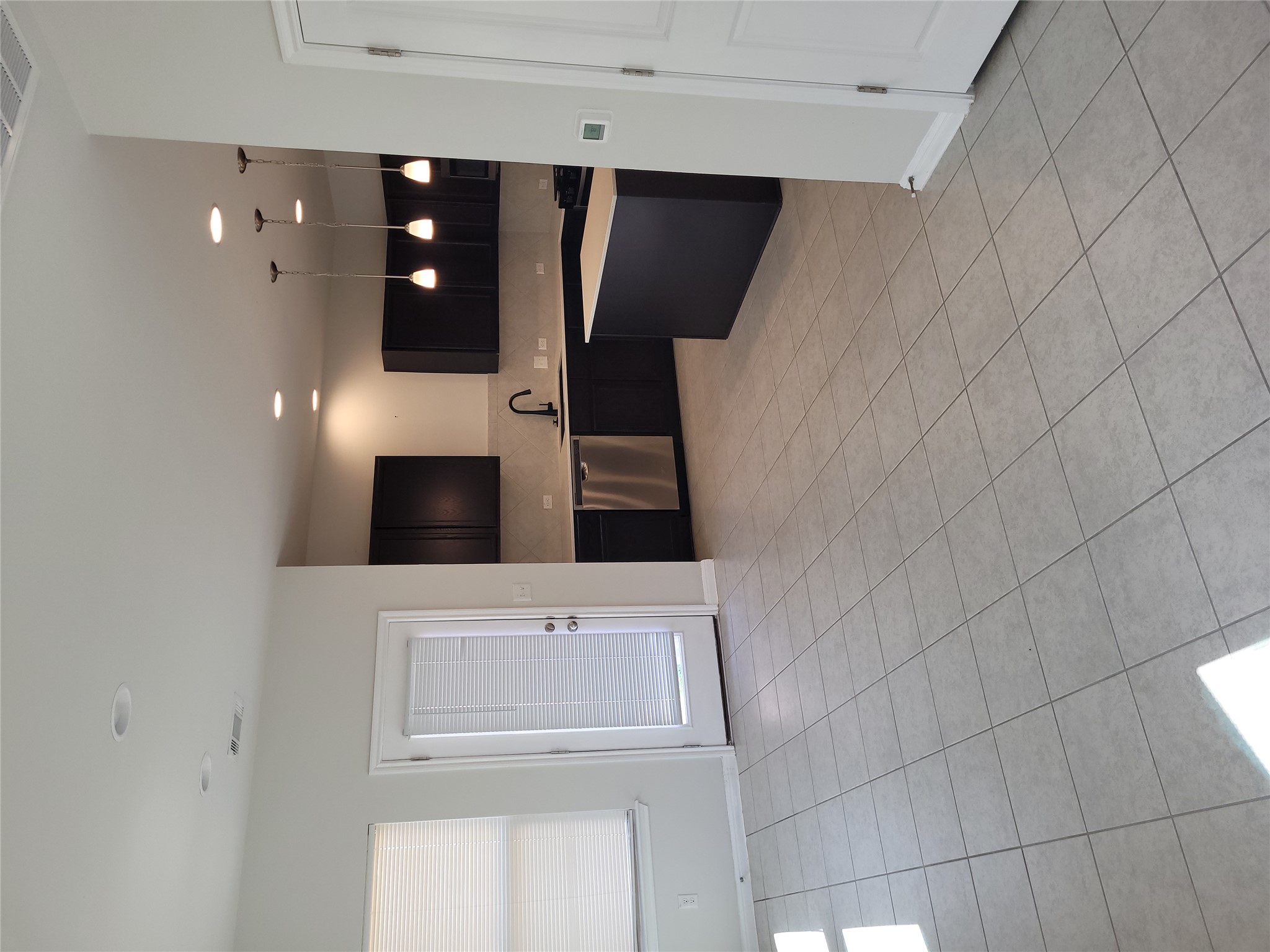 8308 Daisy Cutter Crossing Georgetown, TX 78626 - Photo 4 of 27 An open layout connects the living area with a sleek kitchen, complete with pendant lighting.