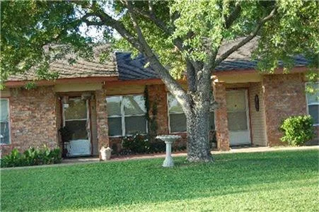 front view of a house with a tree