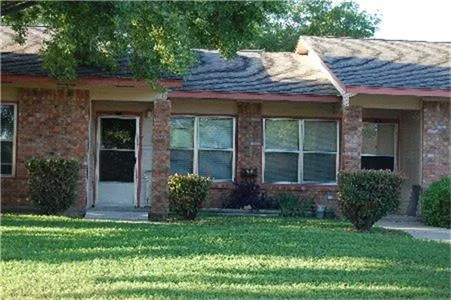 a view of a house with garden and plants