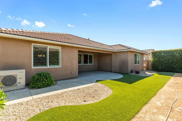 a front view of a house with a yard and porch