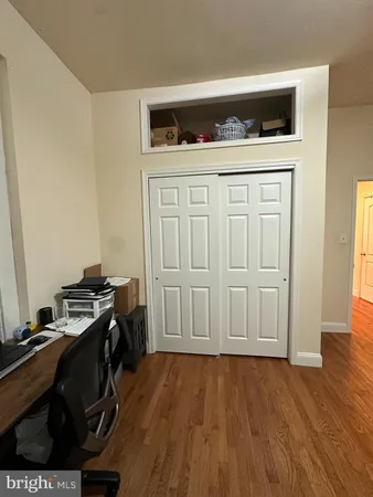 a hallway with a stove and wooden floor