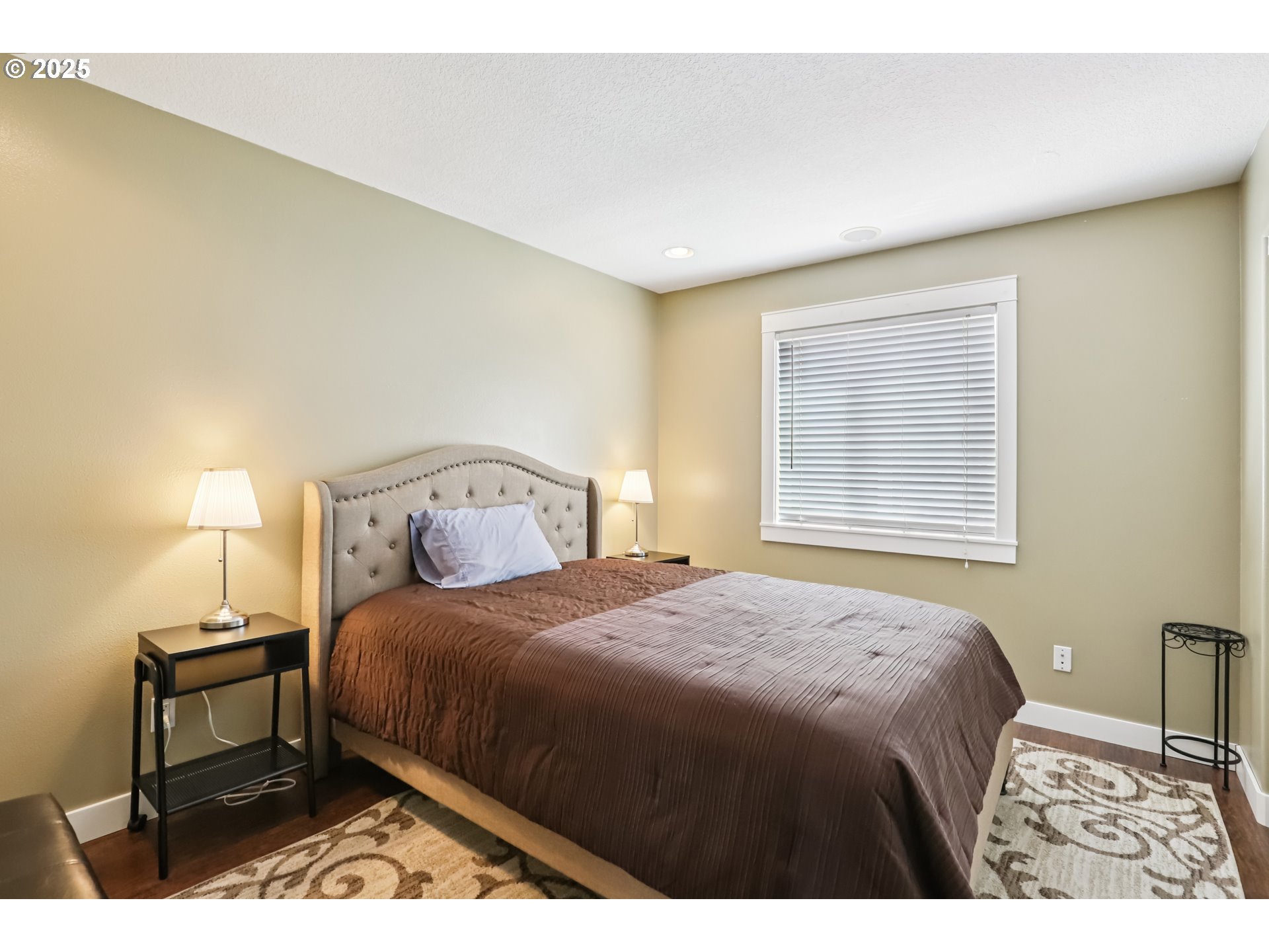 425 Northwest 151st Street Vancouver, WA 98685 - Photo 19 of 31 a bedroom with a bed a dresser and a window