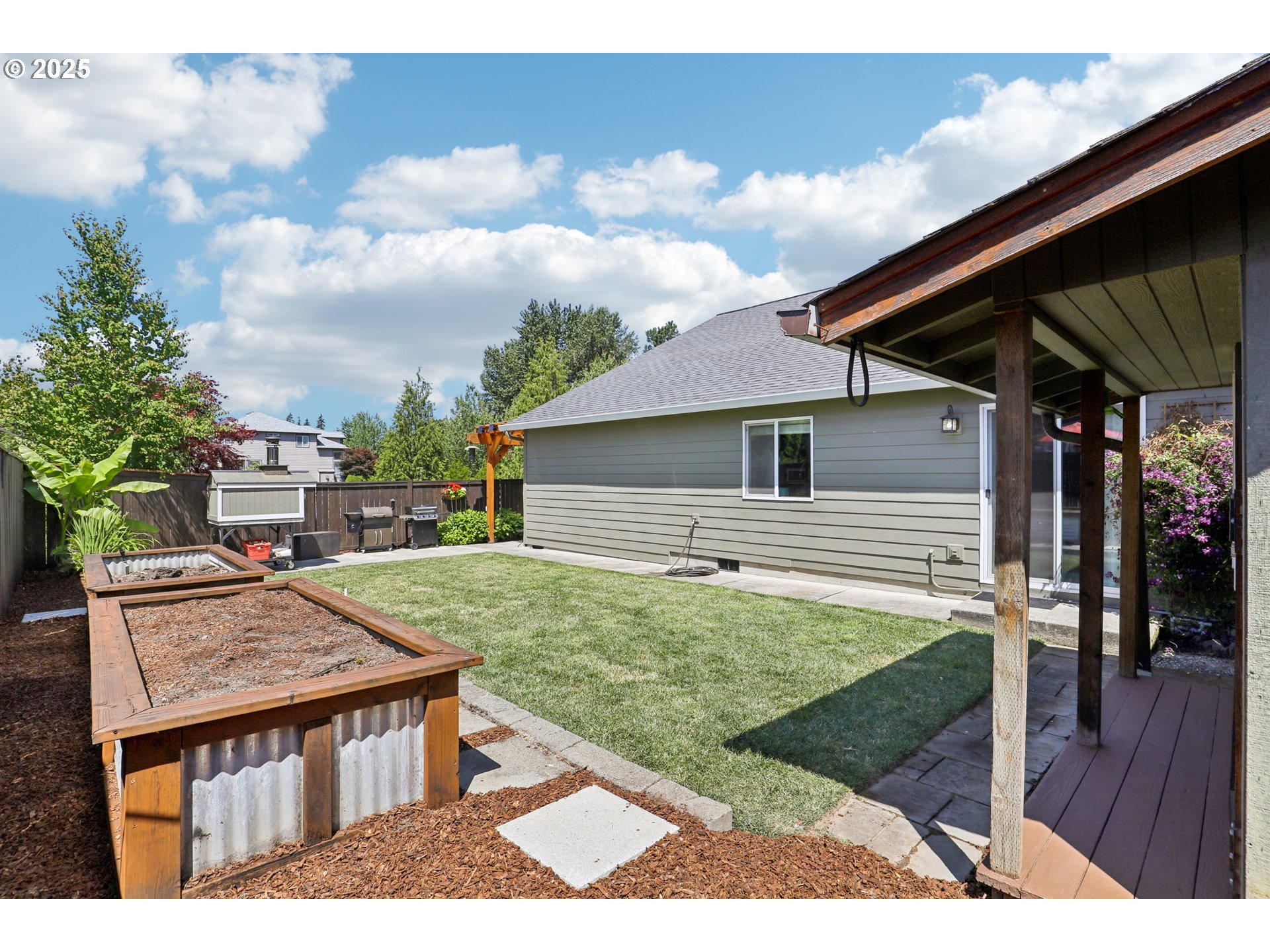 425 Northwest 151st Street Vancouver, WA 98685 - Photo 29 of 31 a backyard of a house with wooden floor table and chairs