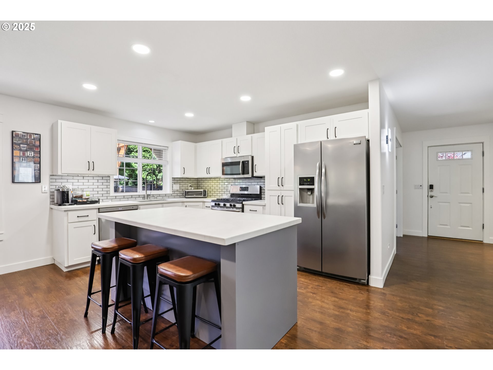 425 Northwest 151st Street Vancouver, WA 98685 - Photo 6 of 31 a kitchen with refrigerator a table and chairs