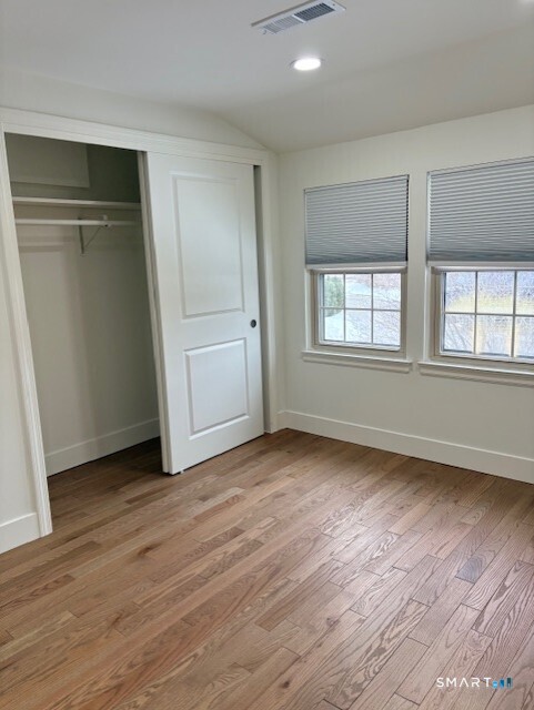 7 Spring Street, Unit 7 Wethersfield, CT 06109 - Photo 12 of 18 an empty room with wooden floor and windows
