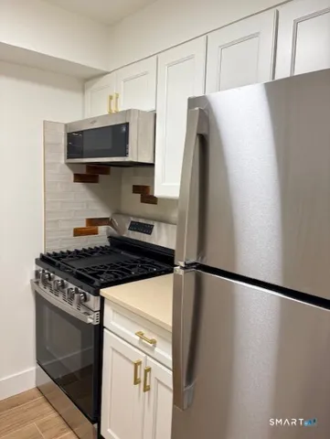 a kitchen with stainless steel appliances a refrigerator and a stove