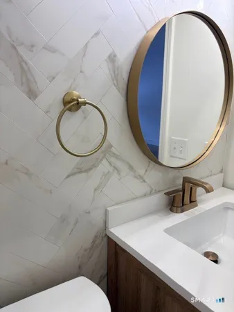 a bathroom with a sink mirror and vanity