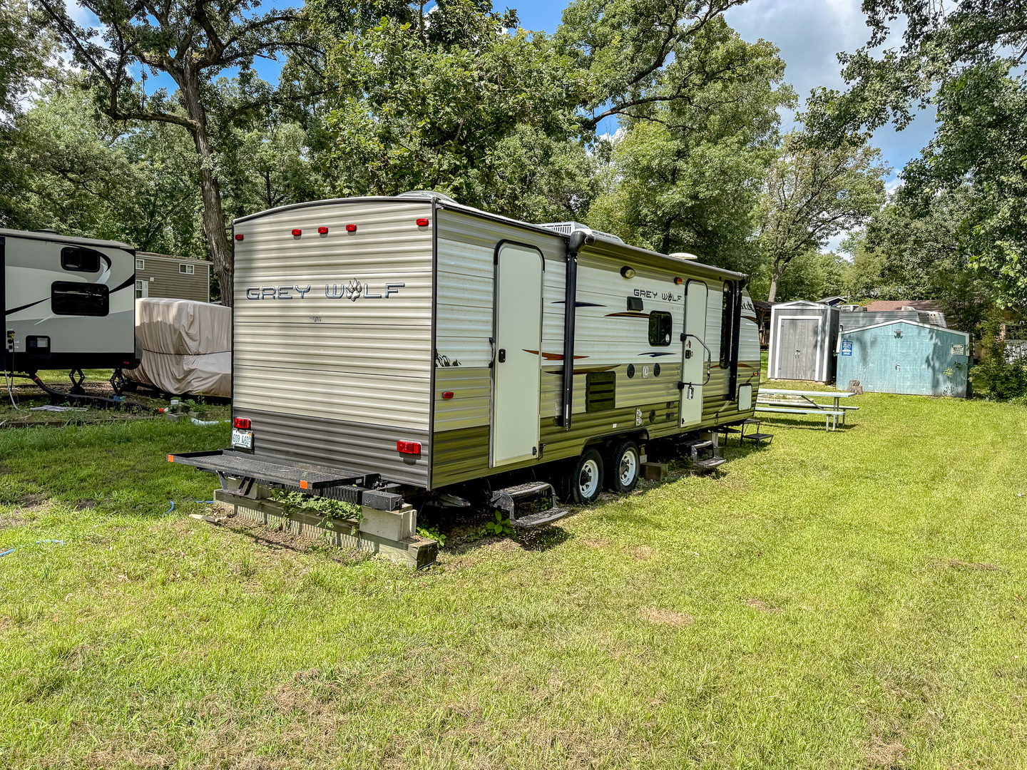 a view of a house with backyard and sitting area