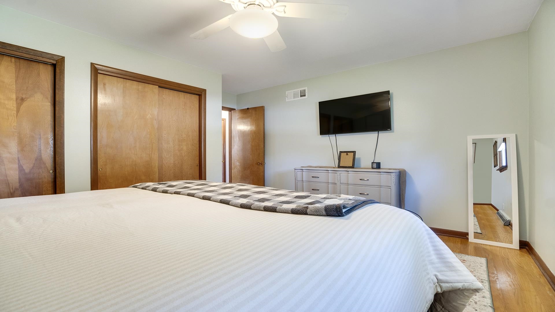 2428 Devon Avenue Loves Park, IL 61111 - Photo 21 of 26 a bedroom with a bed and a flat screen tv