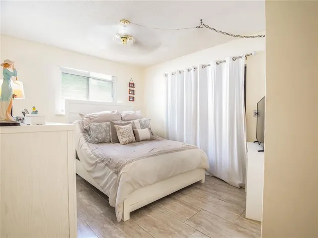 a bedroom with a bed and a window