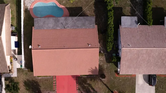 an aerial view of a house with a yard