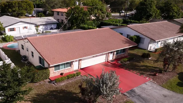 an aerial view of a house with yard