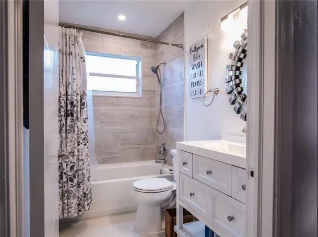 a bathroom with a toilet a sink and a bathtub