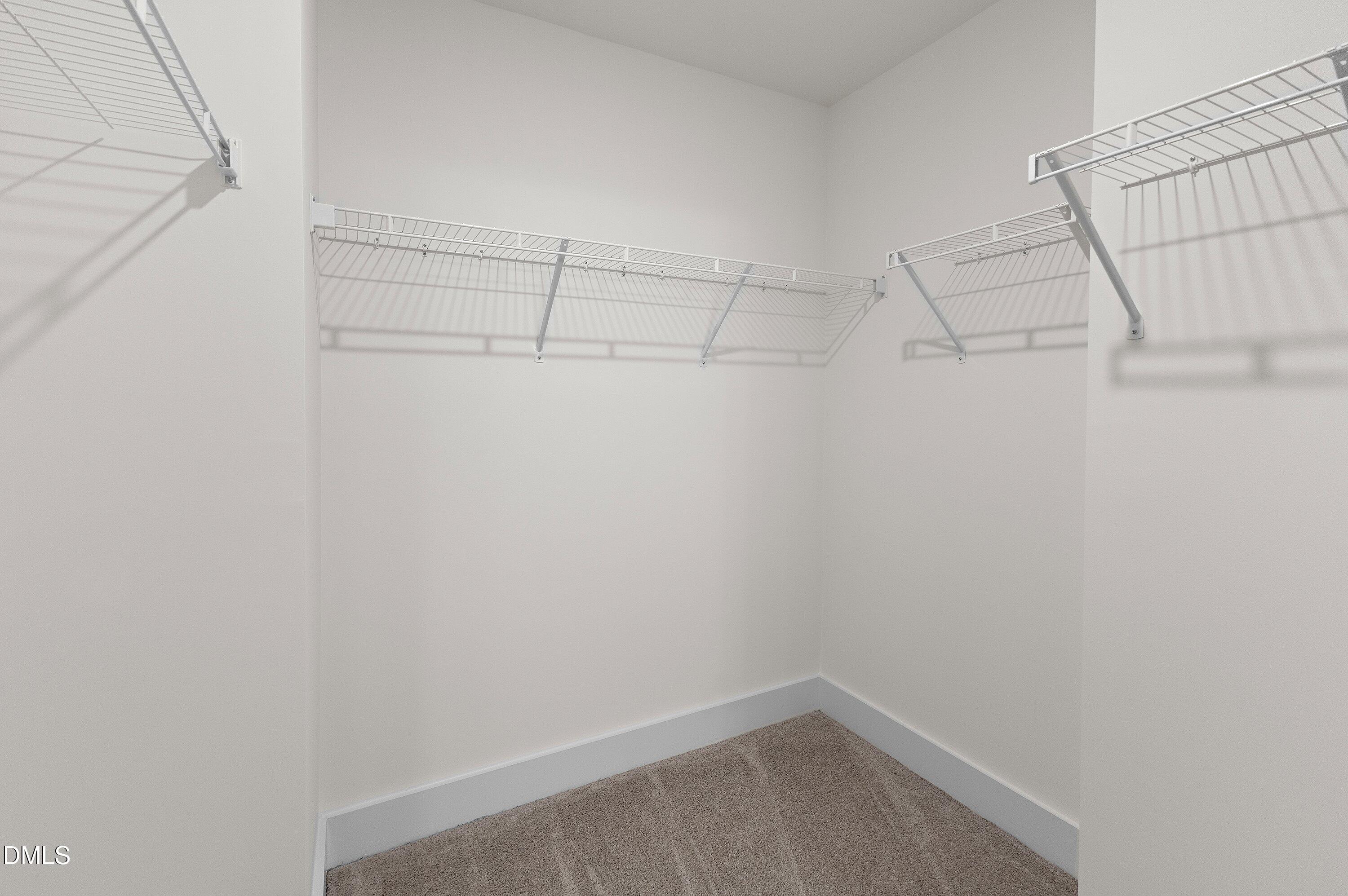 156 Sears Ridge Lane Morrisville, NC 27560 - Photo 24 of 49 a view of a room with racks on the wall