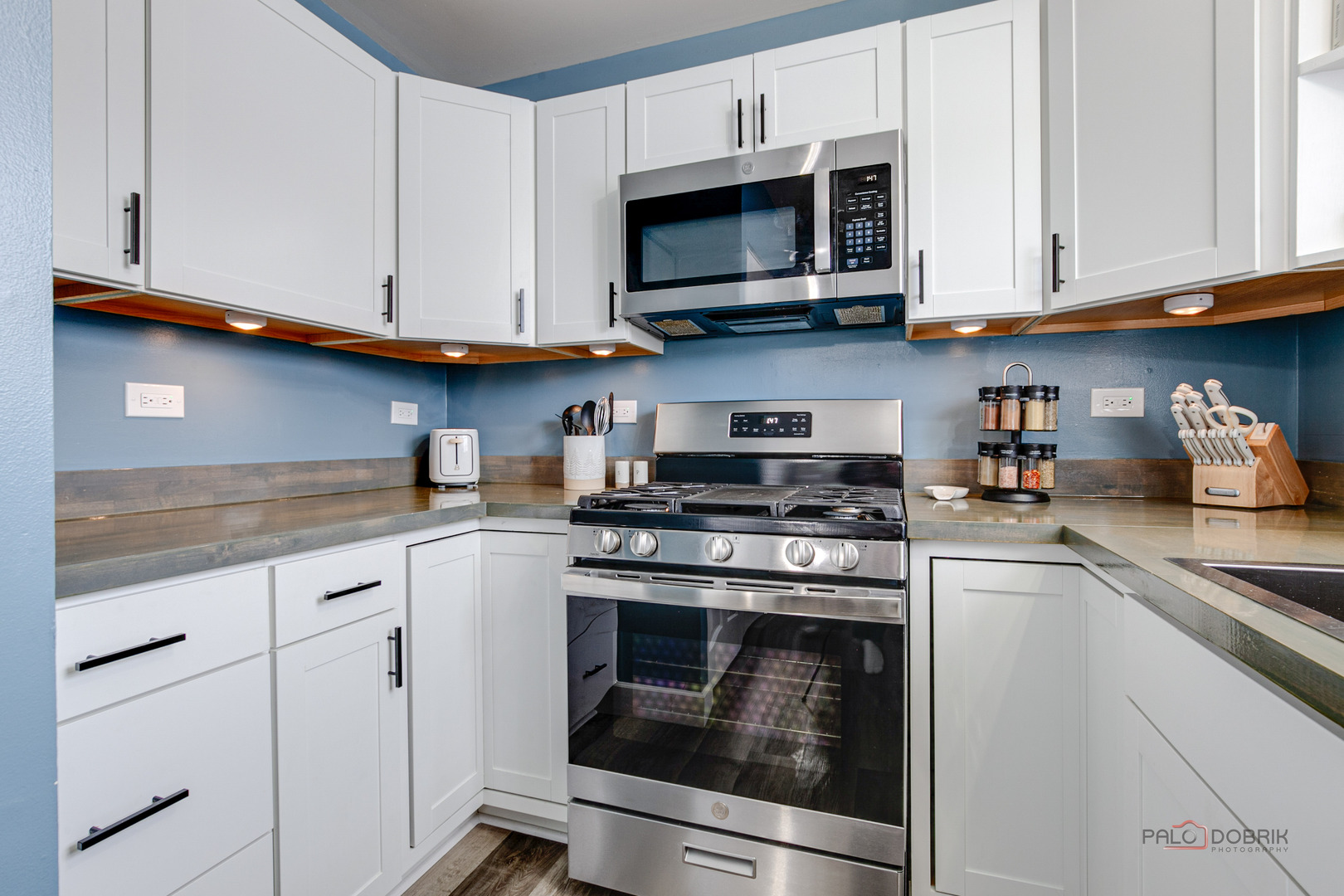 1502 Anderson Trail Zion, IL 60099 - Photo 13 of 30 a kitchen with stainless steel appliances granite countertop grey cabinets a stove a sink and dishwasher